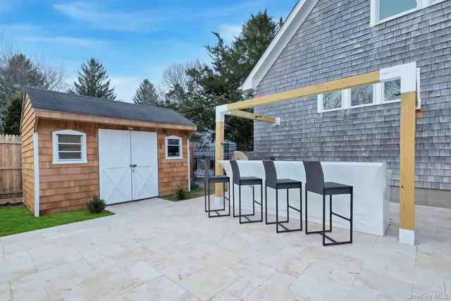 a view of a house with backyard and a porch