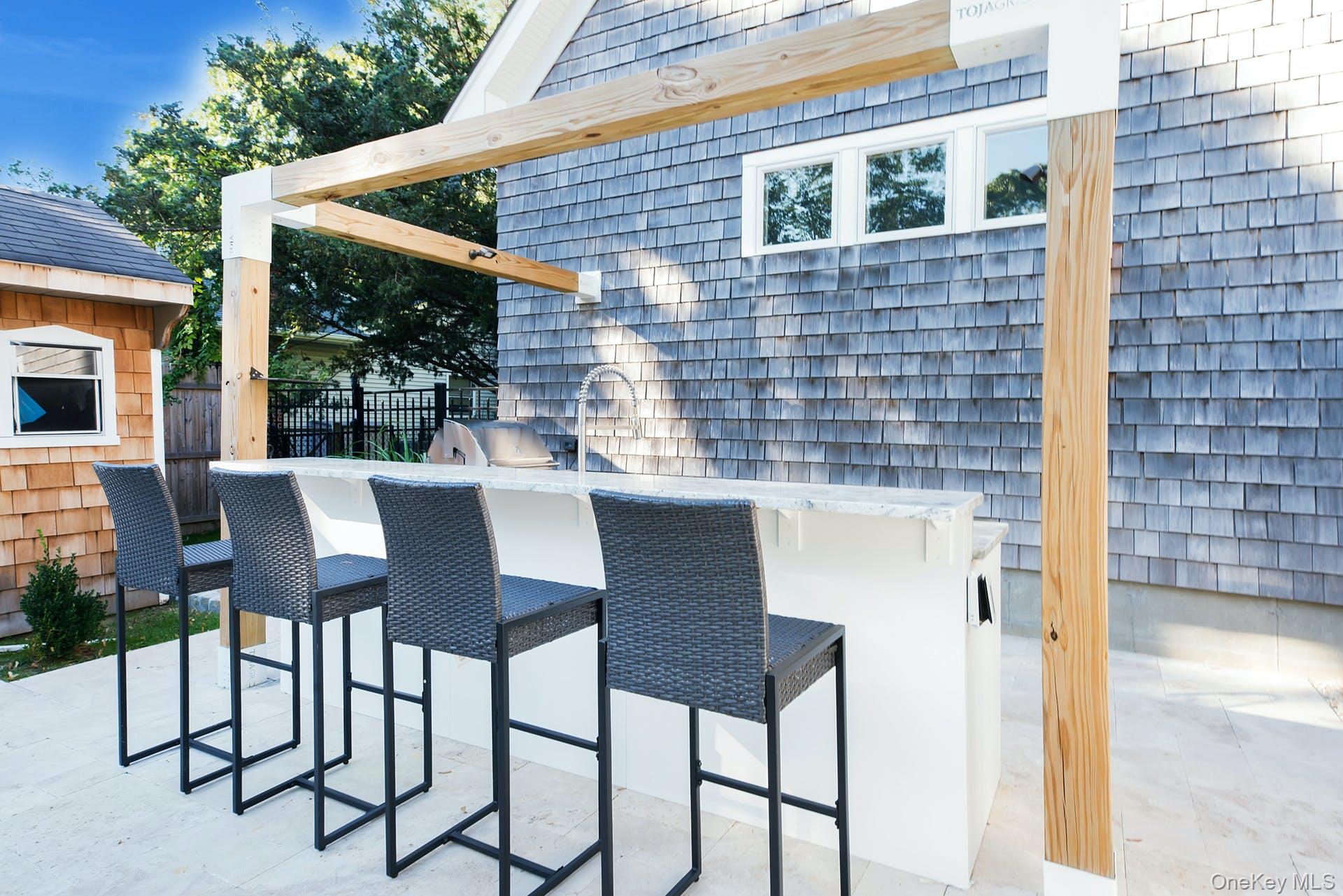 550 Krause Road Mattituck, NY 11952 - Photo 29 of 34 a patio with table and chairs and potted plants
