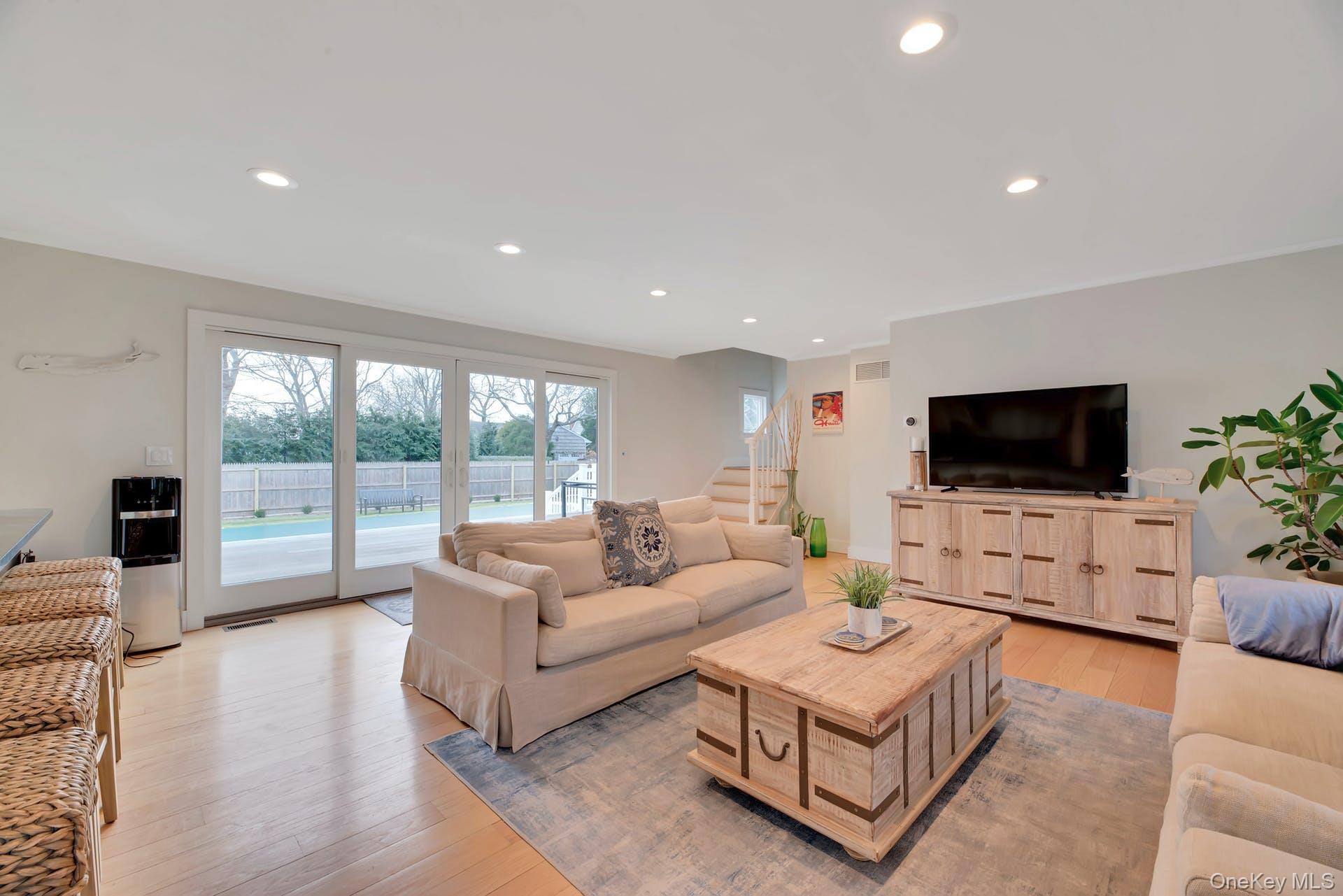 550 Krause Road Mattituck, NY 11952 - Photo 4 of 34 a living room with furniture a flat screen tv and a large window