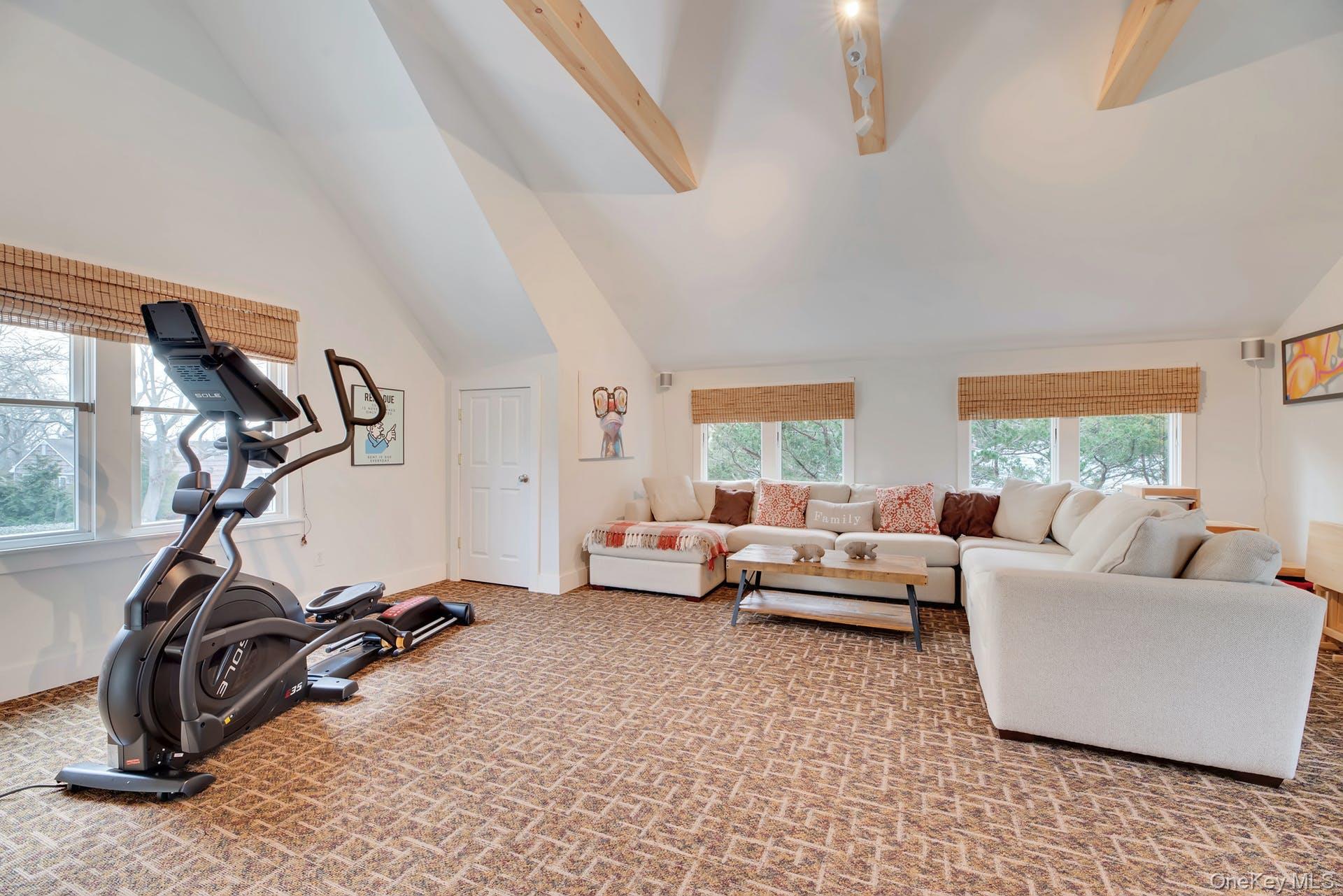550 Krause Road Mattituck, NY 11952 - Photo 6 of 34 a living room with furniture a window and gym equipment