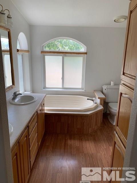 14990 Kivett Lane Reno, NV 89521 - Photo 12 of 16 a bathroom with a tub sink and mirror