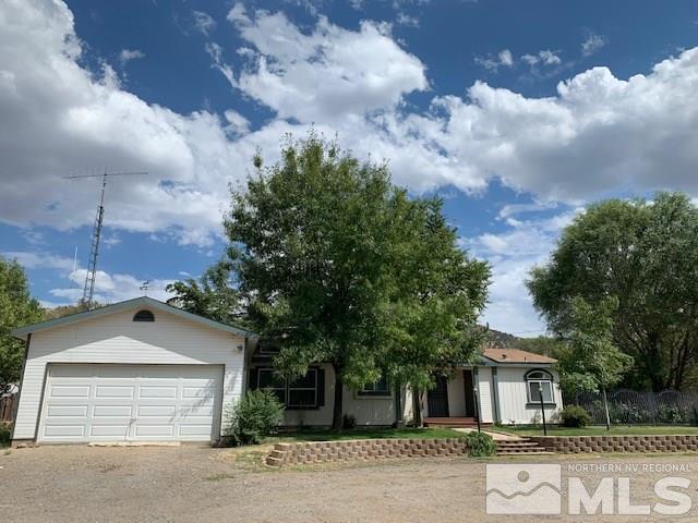 14990 Kivett Lane Reno, NV 89521 - Photo 2 of 16 a front view of a house with a yard and garage