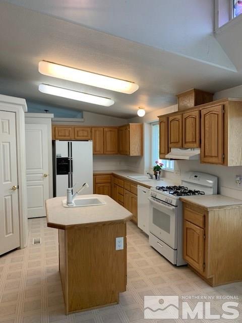 14990 Kivett Lane Reno, NV 89521 - Photo 3 of 16 a kitchen with stainless steel appliances granite countertop a sink stove and refrigerator