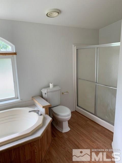 14990 Kivett Lane Reno, NV 89521 - Photo 9 of 16 a bathroom with a toilet a sink a shower and mirror