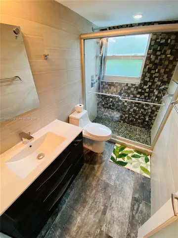 a bathroom with a sink toilet and shower