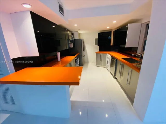 a view of a living room with a flat screen tv