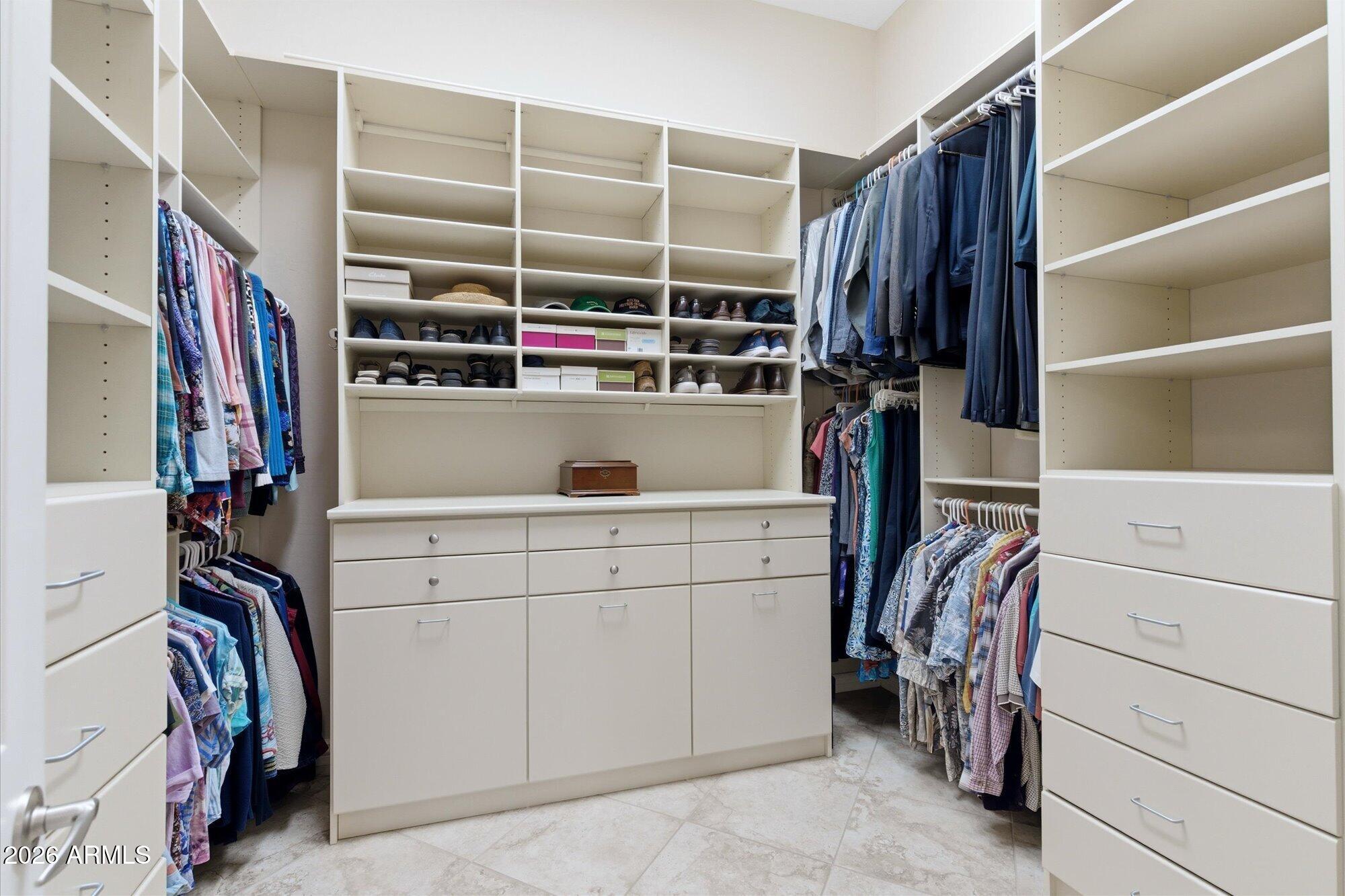 40322 North Hawk Ridge Trail Anthem, AZ 85086 - Photo 32 of 63 a view of walk in closet with clothes and shoes