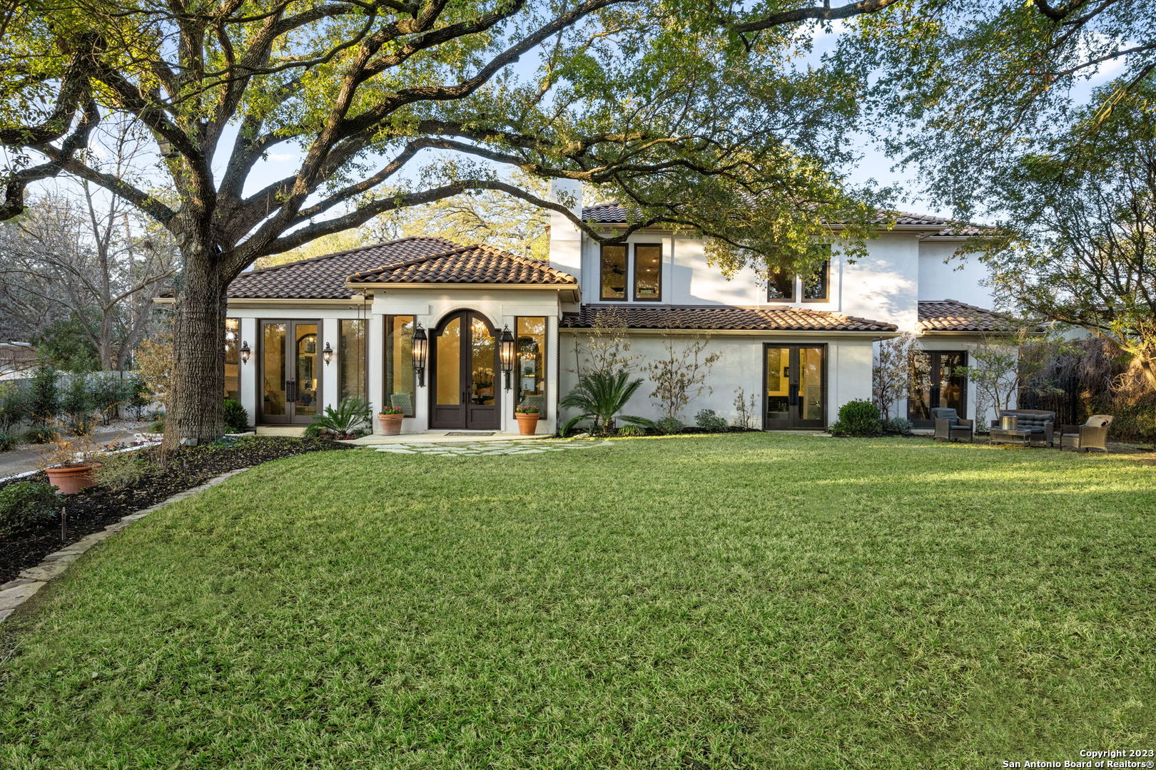 a front view of a house with a garden