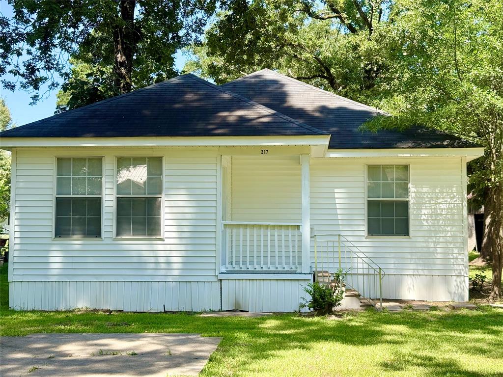 217 3rd St Pinehill Springhill, LA 71075 - Photo 1 of 23 White siding exterior with a dark shingle roof