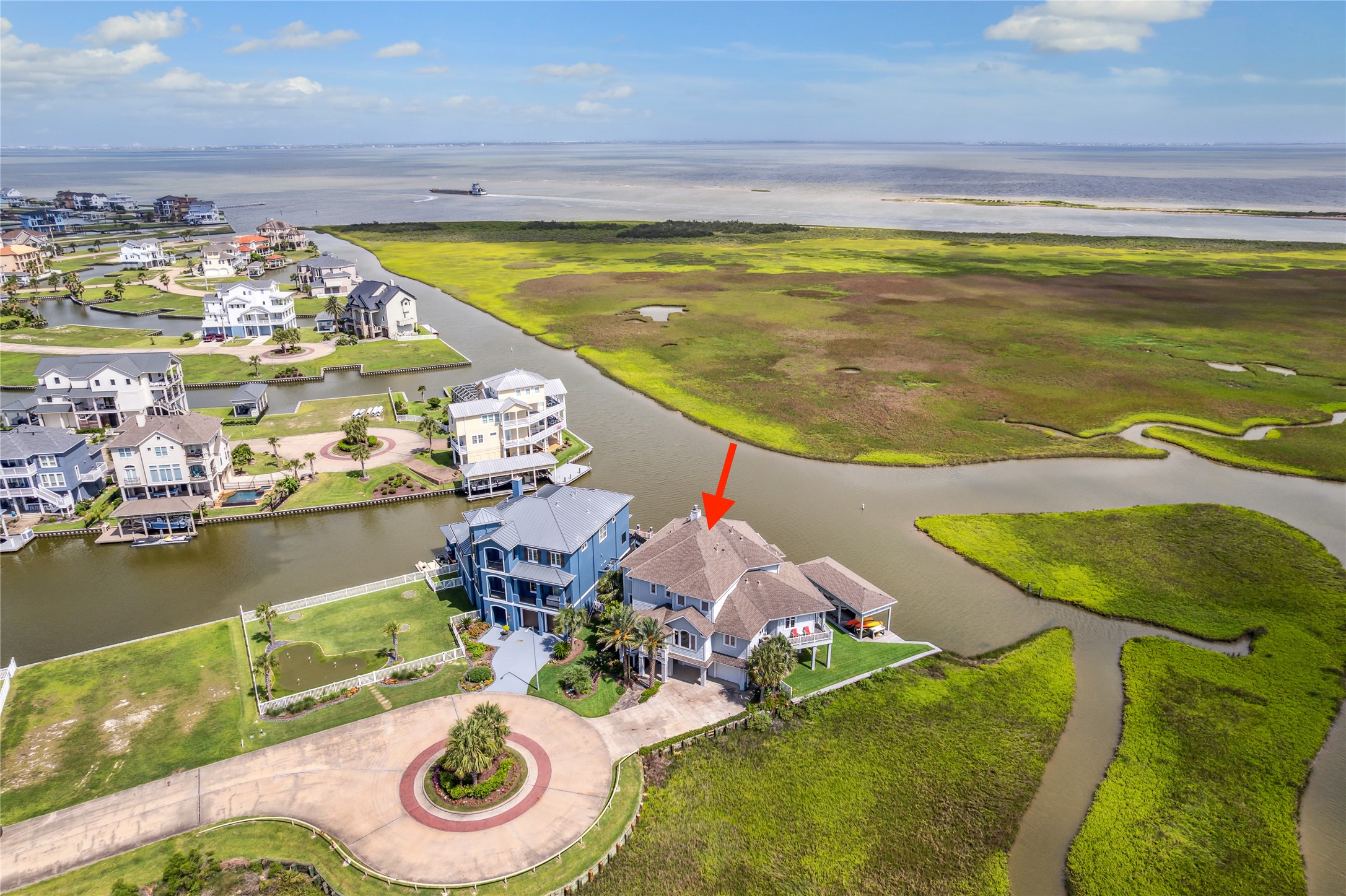 1 Shell Key Hitchcock, TX 77563 - Photo 3 of 50 This stunning waterfront home is perfectly positioned at the tip of a cul-de-sac on a premier homesite offering unparalleled privacy and panoramic views. Situated along a wide canal with immediate access to West Galveston Bay, the home captures expansive vistas of the coastal wetlands and open water beyond. The unique placement provides unobstructed sightlines in multiple directions, showcasing the beauty of the surrounding nature preserve and vibrant sunsets