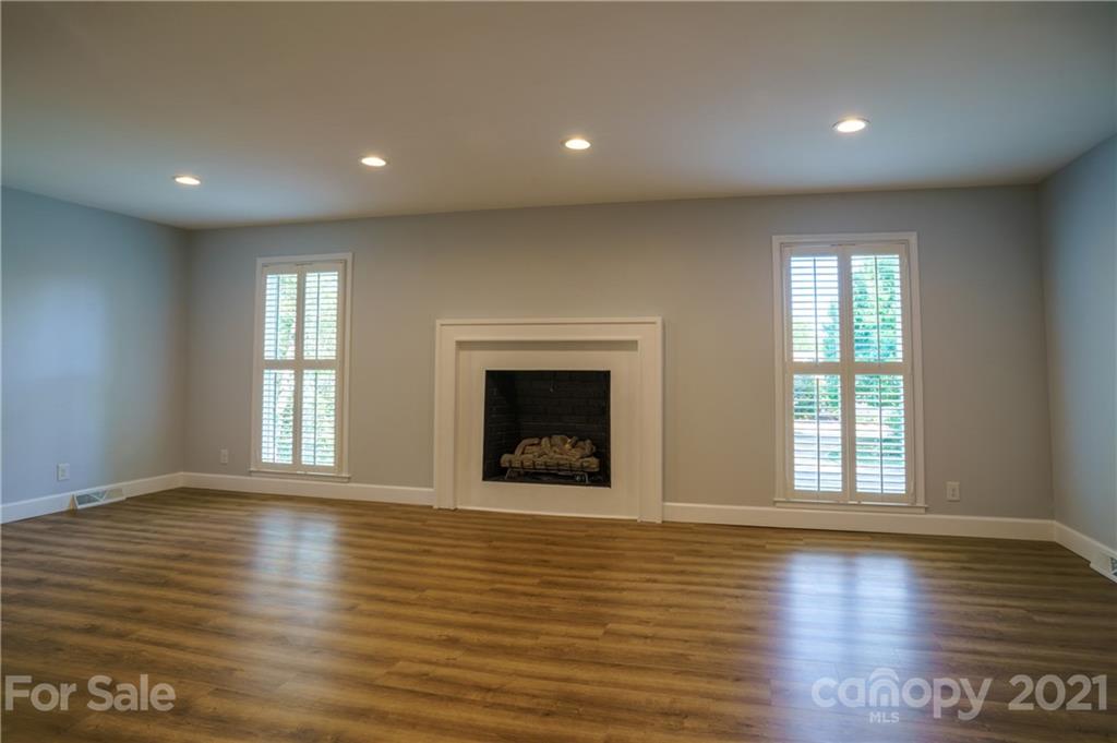 119 Friendfield Drive Fort Mill, SC 29715 - Photo 9 of 24 an empty room with wooden floor and windows