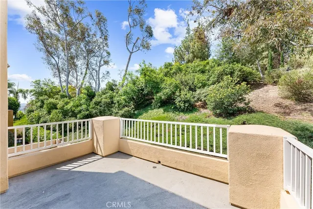 a view of balcony with wooden floor and fence