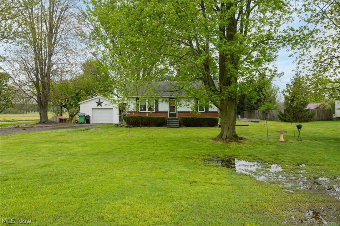 10190 Penniman Road Orwell, OH 44076 - Photo 2 of 24 Ranch-style residence featuring a white facade with brick accenting and a covered front entry