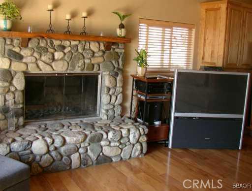 26436 Apache Lake Rimforest, CA 92378 - Photo 3 of 7 a bedroom with a bed and a window
