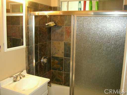 26436 Apache Lake Rimforest, CA 92378 - Photo 4 of 7 a bathroom with a sink mirror and shower