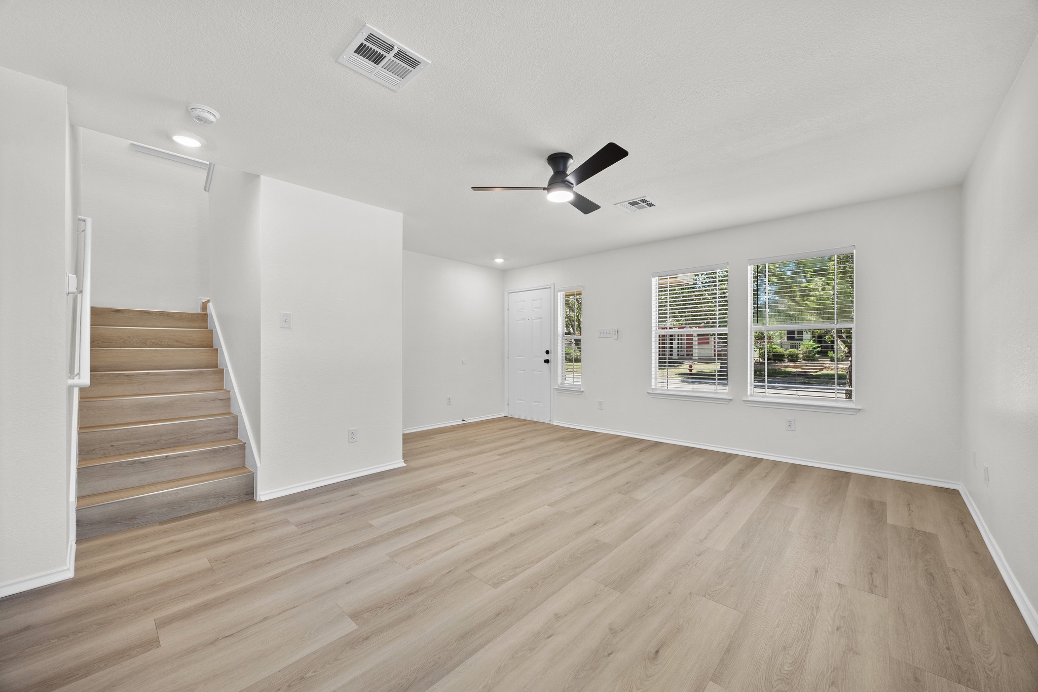 1818 Lost Maples Loop Cedar Park, TX 78613 - Photo 5 of 38 A well-lit living area features ample natural light, durable flooring, and convenient stair access to the upper level.