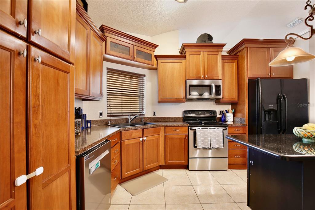 300 Springview Drive Sanford, FL 32773 - Photo 14 of 55 a kitchen with stainless steel appliances granite countertop a sink and cabinets