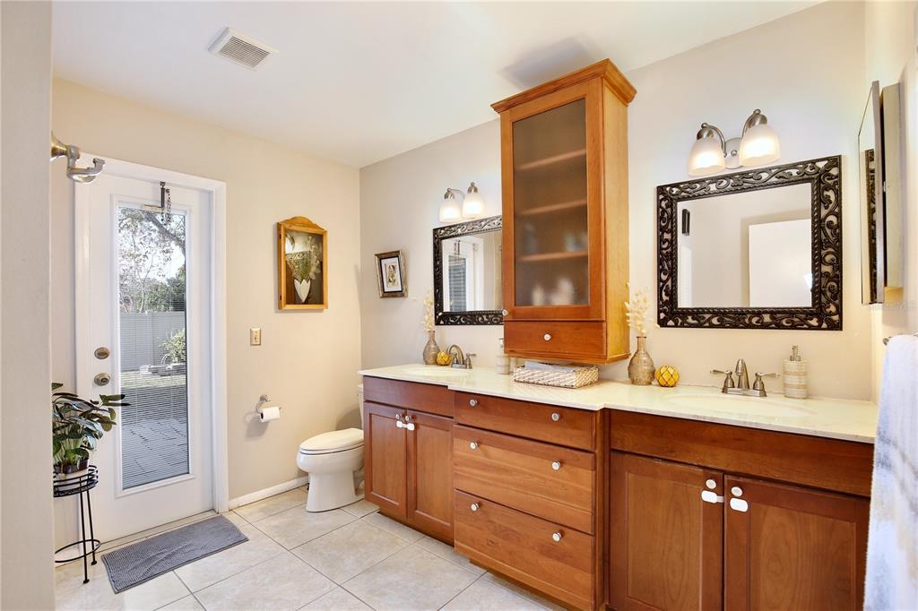 300 Springview Drive Sanford, FL 32773 - Photo 21 of 55 a bathroom with a double vanity sink a toilet and a mirror