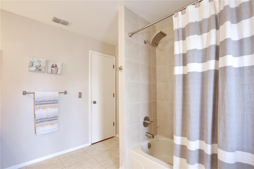 300 Springview Drive Sanford, FL 32773 - Photo 22 of 55 a bathroom with a bathtub and a shower