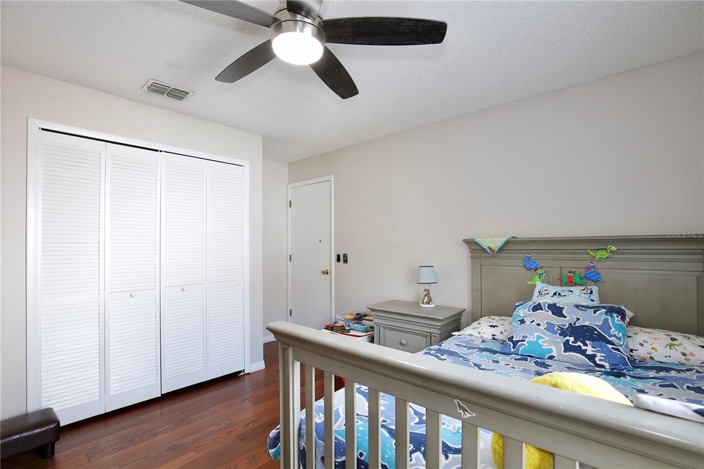 300 Springview Drive Sanford, FL 32773 - Photo 24 of 55 a bedroom with a bed and wooden floor