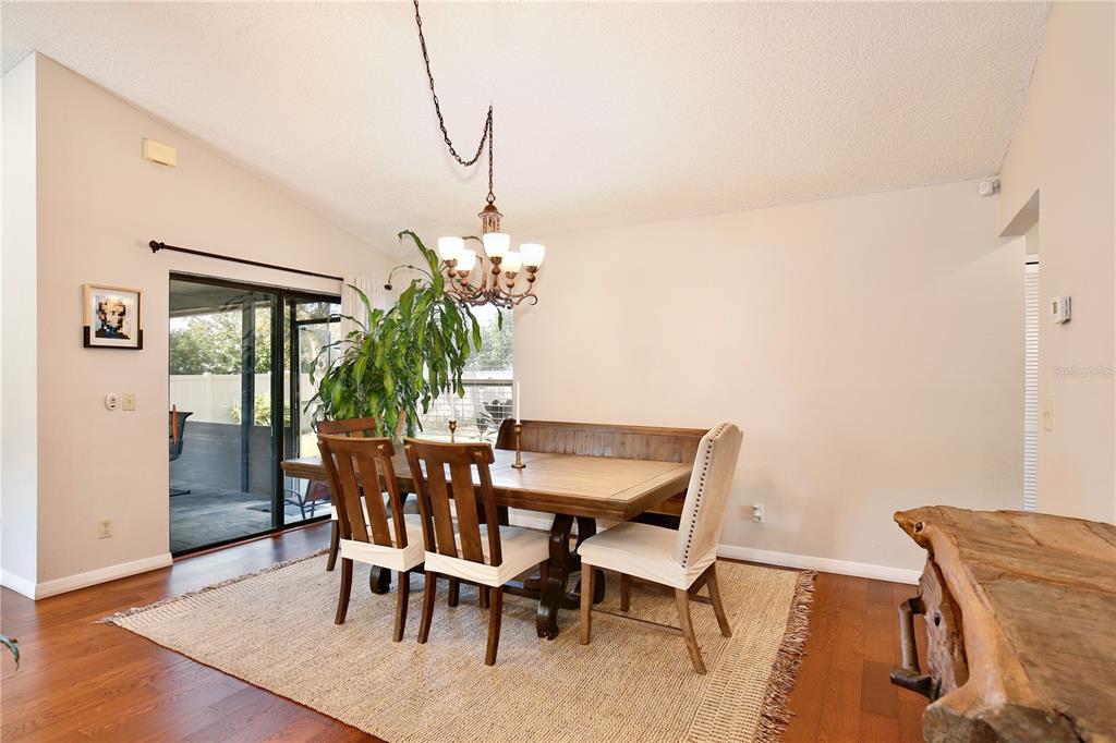 300 Springview Drive Sanford, FL 32773 - Photo 10 of 55 a view of a dining room with furniture and wooden floor
