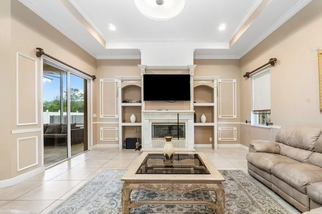 a living room with furniture a fireplace and a flat screen tv