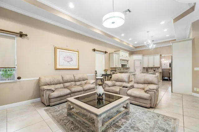 a living room with furniture a chandelier and a table