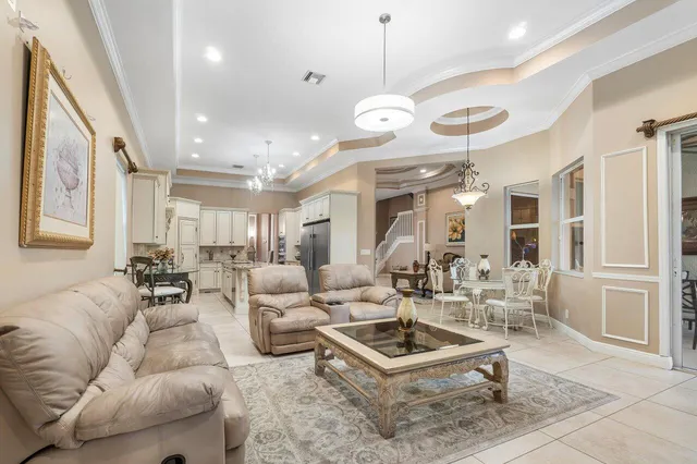 a kitchen with stainless steel appliances kitchen island granite countertop a refrigerator and a stove top oven