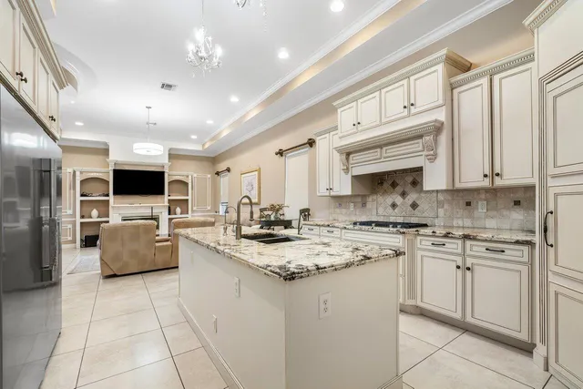 a kitchen with stainless steel appliances granite countertop a sink stove and cabinets