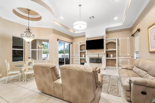 a living room with furniture or wooden floor and a large window