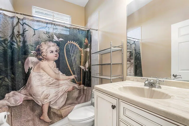 a living room with furniture a chandelier and a flat screen tv