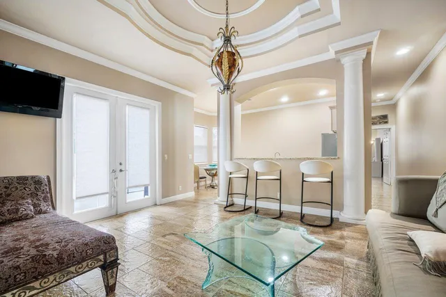 a living room with furniture and a chandelier