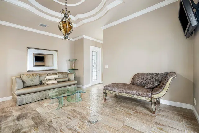 a living room with furniture and a chandelier