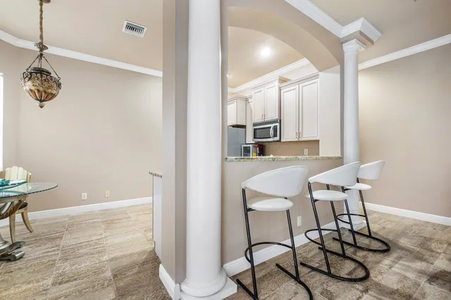 a kitchen with granite countertop a refrigerator stove top oven and sink