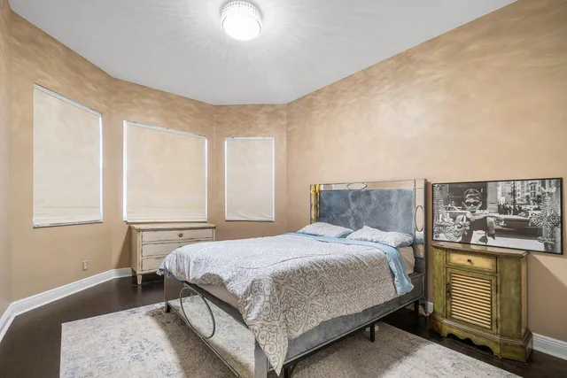 a bedroom with a bed chair and window