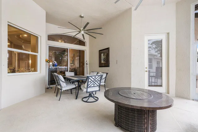 a view of a house with backyard and sitting area