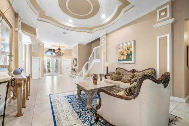 a living room with furniture a flat screen tv and a large window