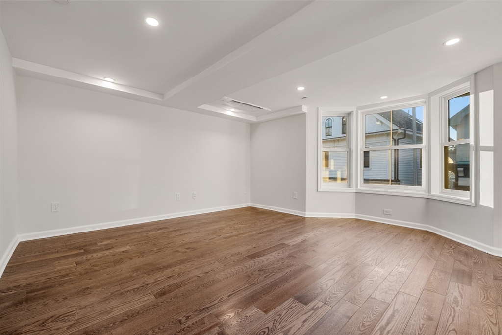 1 School Street, Unit R2 Manchester, MA 01944 - Photo 4 of 13 a view of an empty room with wooden floor and windows