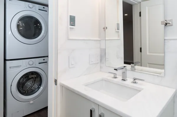 a utility room with sink dryer and washer