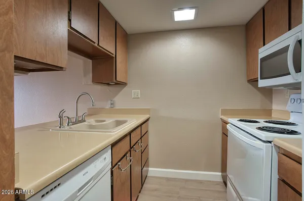 a kitchen with stainless steel appliances granite countertop a sink and a stove top oven
