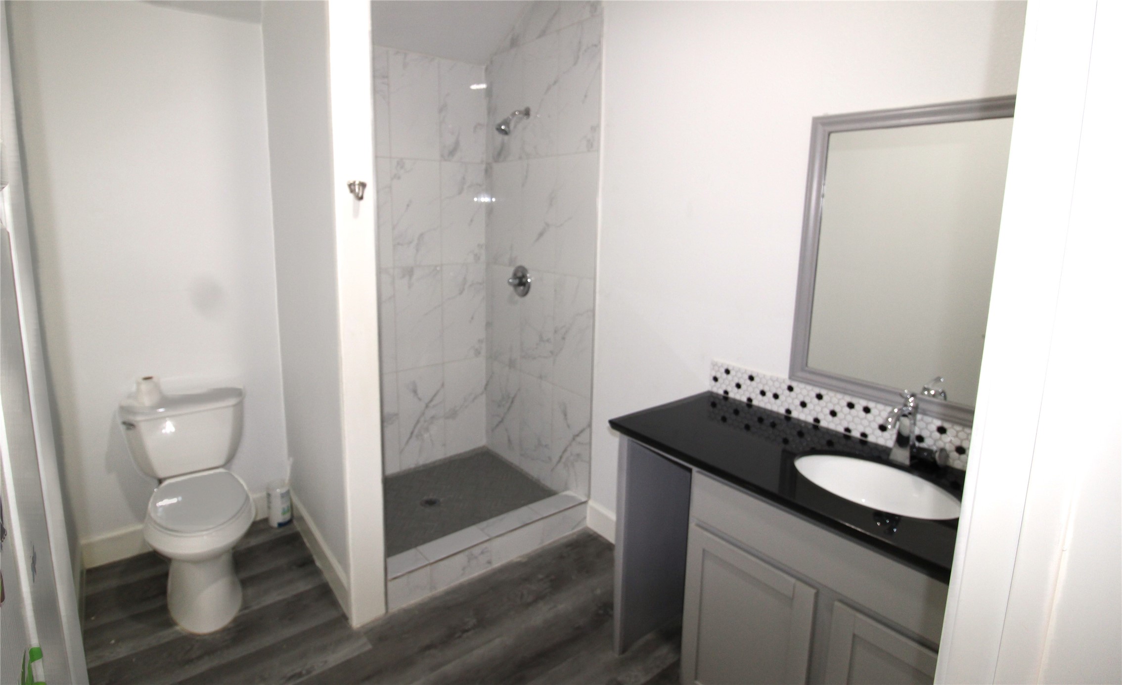 820 Railroad Avenue Shepherd, TX 77371 - Photo 19 of 29 a bathroom with a granite countertop sink a toilet and shower