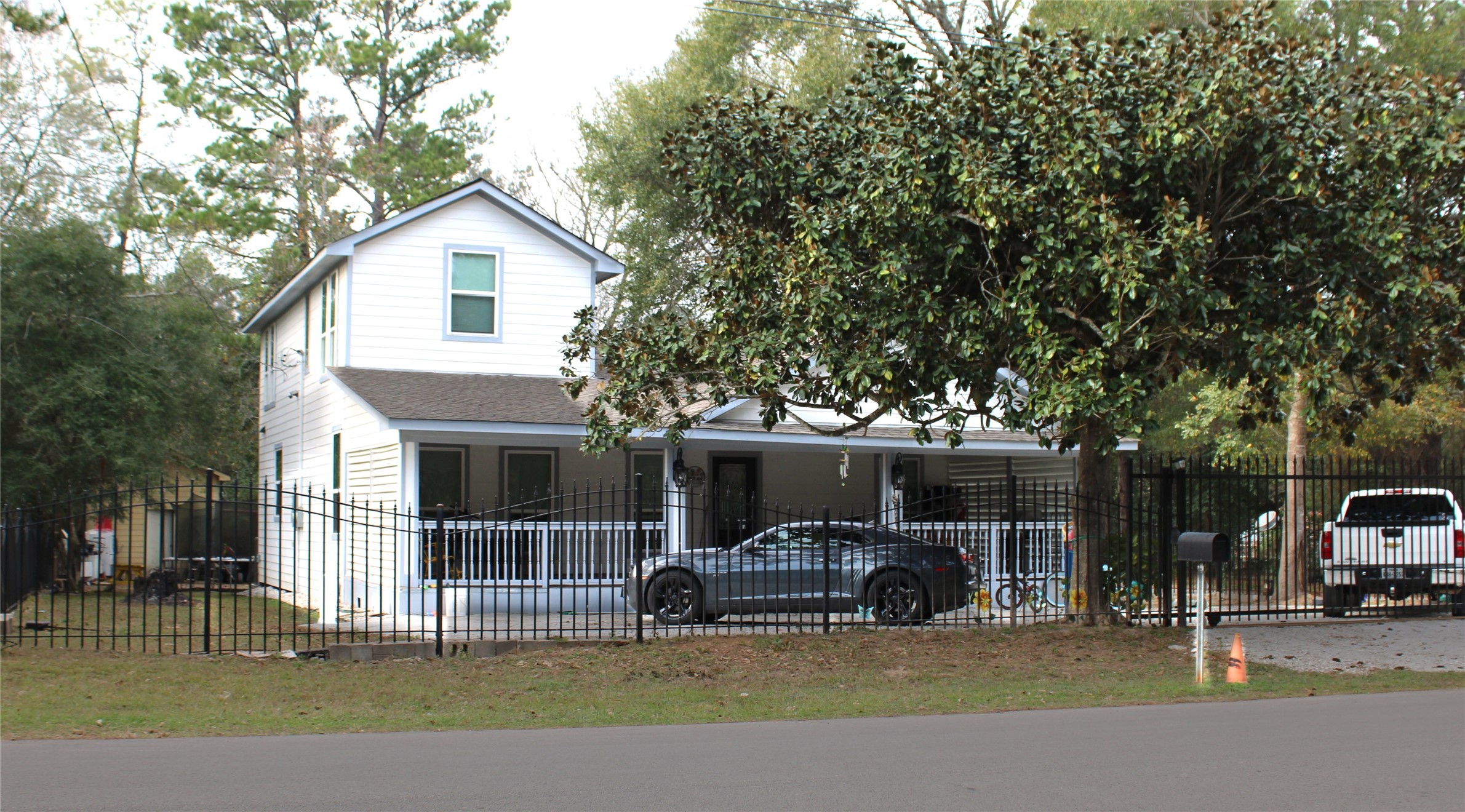 820 Railroad Avenue Shepherd, TX 77371 - Photo 2 of 29 a front view of a house with cars parked