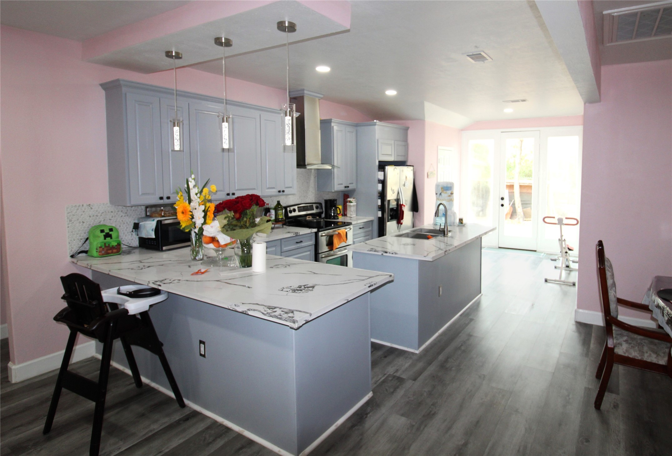 820 Railroad Avenue Shepherd, TX 77371 - Photo 7 of 29 a room with stainless steel appliances kitchen island granite countertop a table chairs and a refrigerator