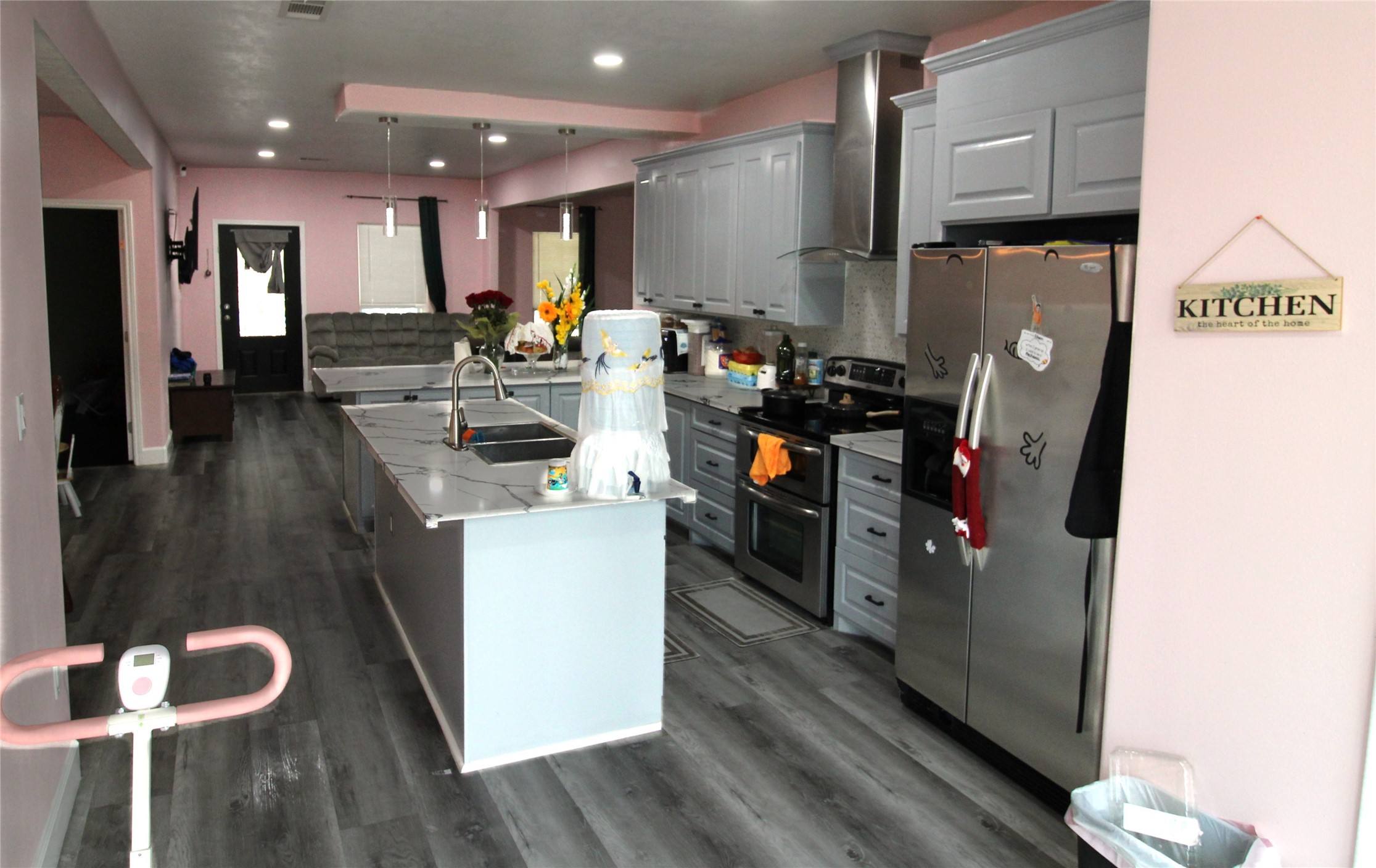 820 Railroad Avenue Shepherd, TX 77371 - Photo 10 of 29 a kitchen with stainless steel appliances granite countertop a refrigerator a sink a stove and a refrigerator with wooden floor