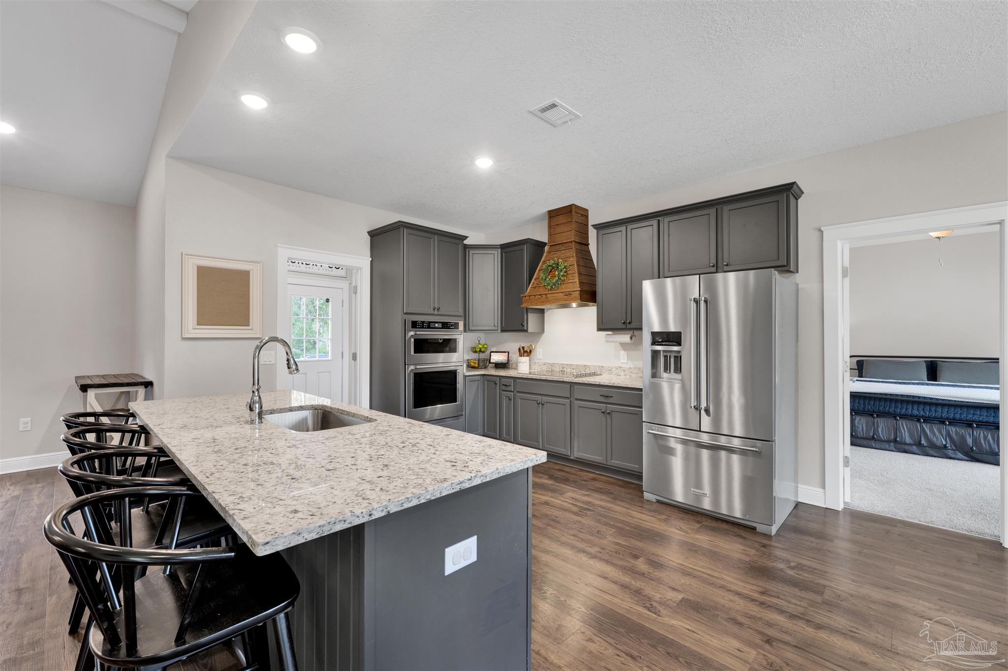4363 Morristown Road Jay, FL 32565 - Photo 11 of 37 a kitchen with a refrigerator a sink and a stove