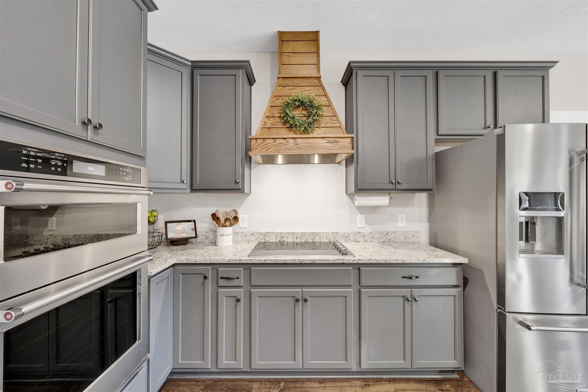 4363 Morristown Road Jay, FL 32565 - Photo 12 of 37 a kitchen with granite countertop stainless steel appliances a refrigerator a stove a microwave and cabinets