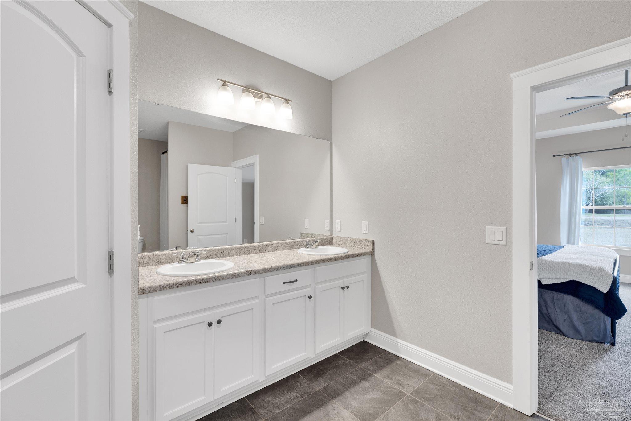 4363 Morristown Road Jay, FL 32565 - Photo 17 of 37 a en suite bathroom with a granite countertop sink and a mirror