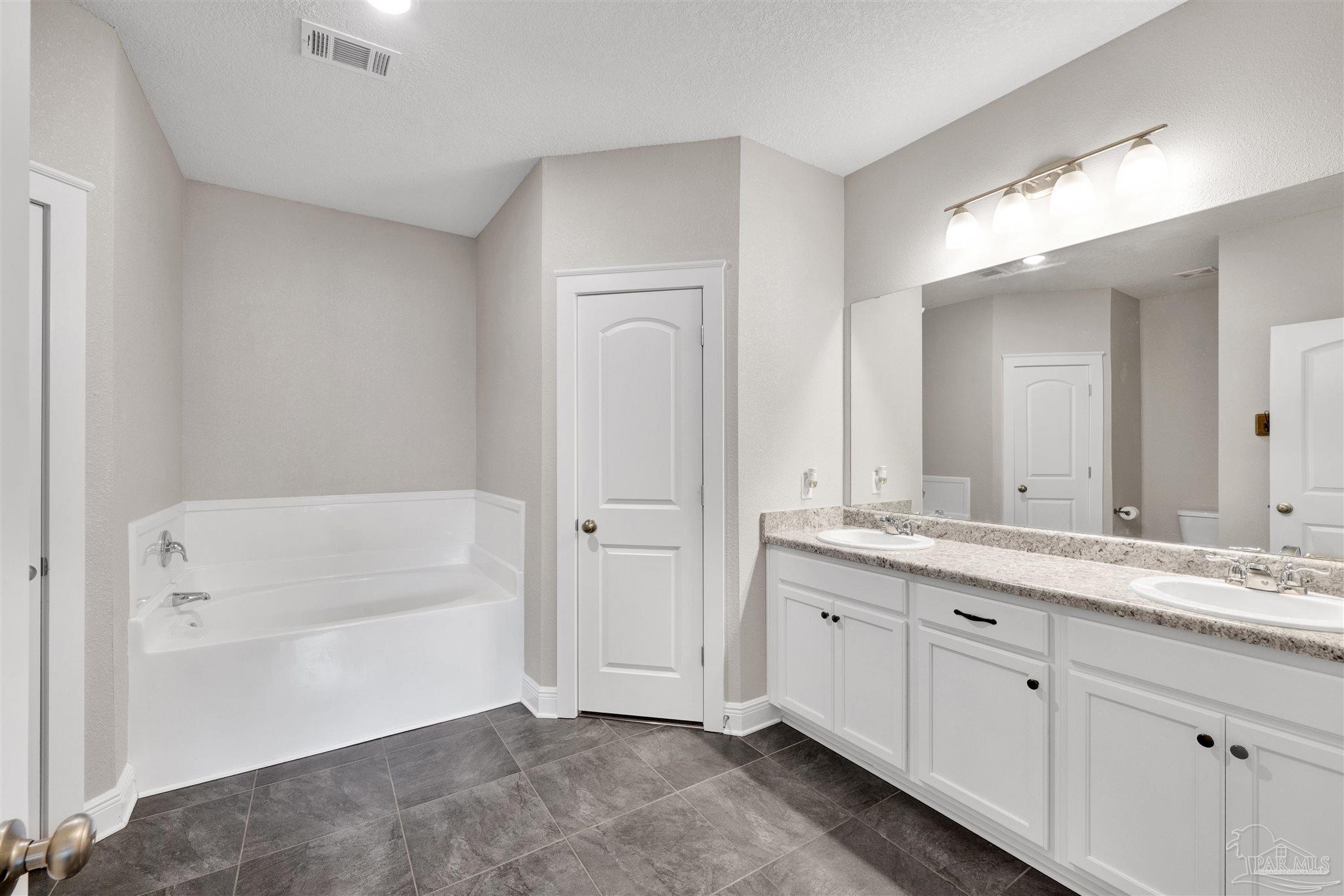 4363 Morristown Road Jay, FL 32565 - Photo 18 of 37 a spacious bathroom with a tub sink and mirror