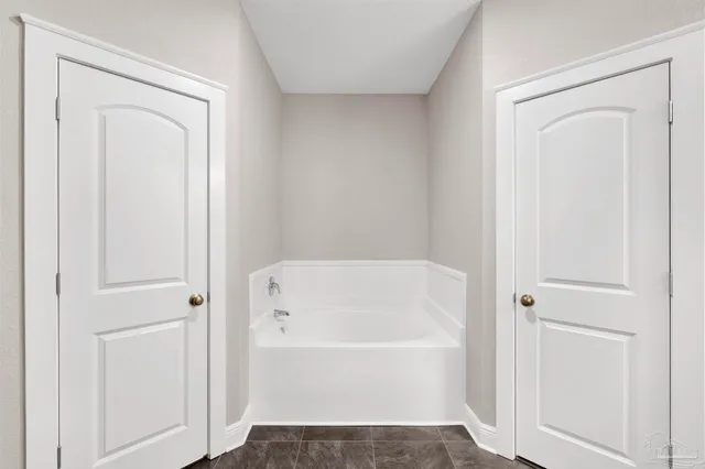 a white bath tub sitting next to a shower