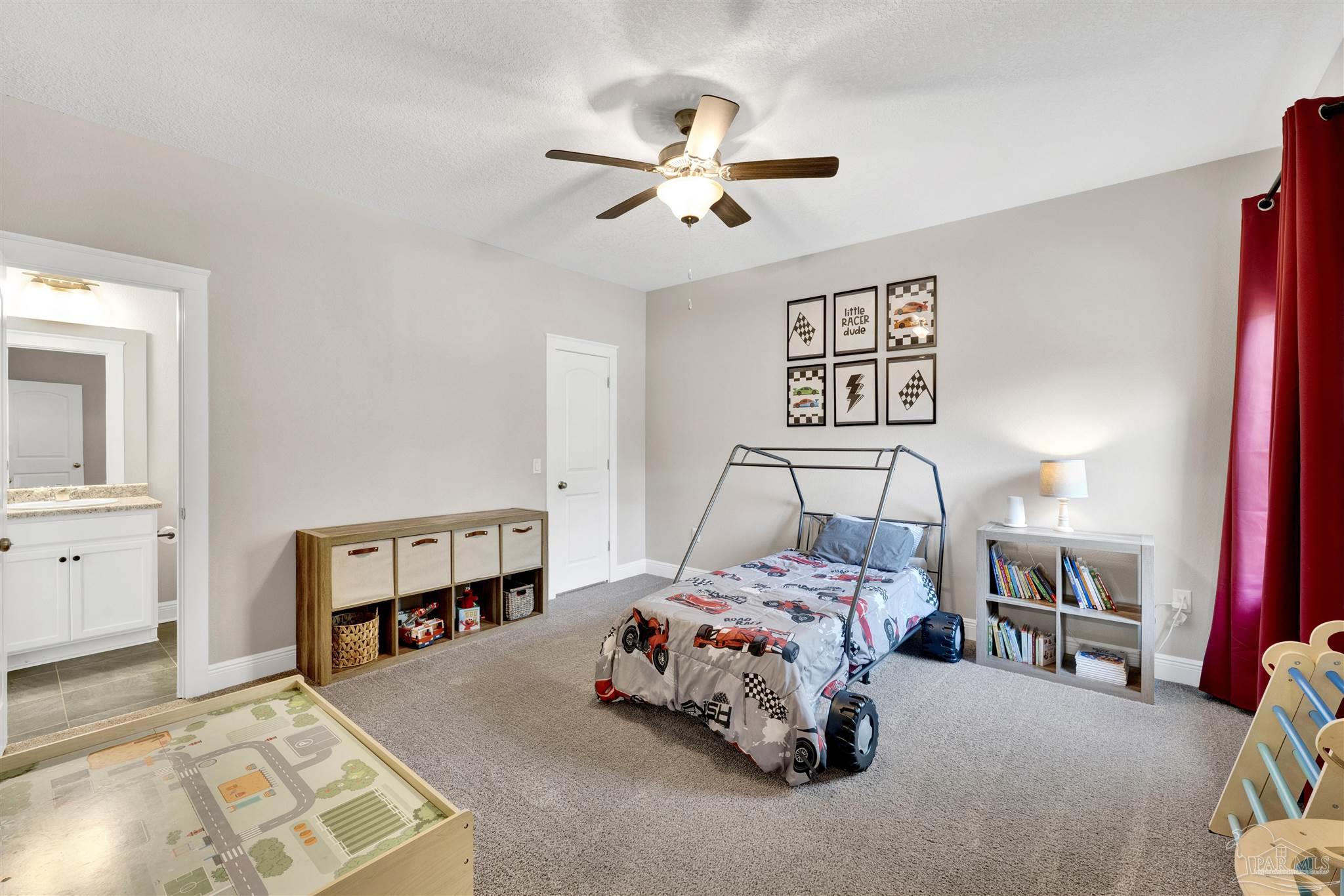 4363 Morristown Road Jay, FL 32565 - Photo 20 of 37 a bedroom with a bed and a chandelier